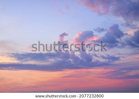 Clear sky, glowing cirrus and cumulus clouds after the storm, soft sunlight. Dramatic sunset cloudscape. Meteorology, weather, climate, heaven, peace. Graphic resources. Picturesque panoramic scenery Royalty-Free Stock Photo #2077232800