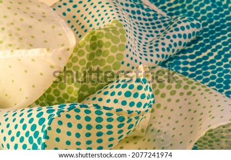 silk fabric. Blue and green pattern with polka dots on a beige background. Texture. for web design, desktop wallpaper, winter blog, website or invitation card.