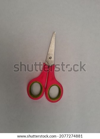Scissors in red and chrome on a white background