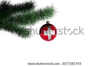 New Year's ball with the flag of Switzerland on a Christmas tree branch isolated on white background. Christmas and New Year concept.