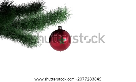 New Year's ball with the flag of Morocco on a Christmas tree branch isolated on white background. Christmas and New Year concept.