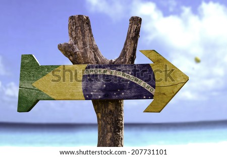 Brazil wooden sign with a beach on background 
