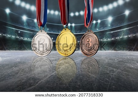 real Gold, silver and bronze medals in the large, illuminated winter ice stadium - 3D illustration
