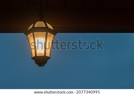 black iron lantern in retro style. lights in the night. background picture. space for printing.