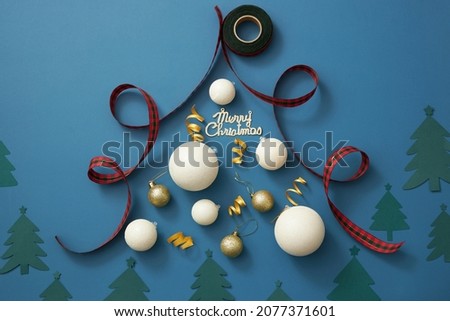 Top view blue blackground holiday christmas with white twinkle pearl and red ribbons pine tree for christmas holiday advertising , top view