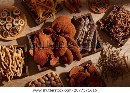 Traditional chinese medicine with herb and spices in brown wooden background , for medicine advertising , photography traditional medicine content