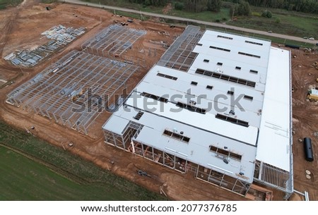 Warehouse Construction from metal structure. Steel Structure Warehouse Building on light gauge steel framing. Aerial view of construction the warehouse from steel structure. Construction site.

 Royalty-Free Stock Photo #2077376785