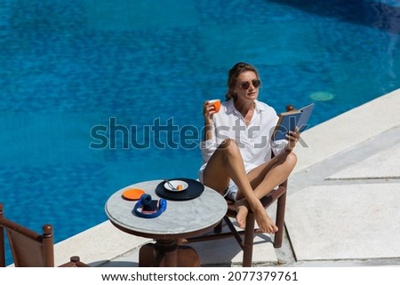 beautiful woman having breakfast near the pool. high quality photo