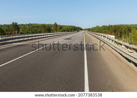 Asphalt road. Automobile bridge over the railway in Siberia.
