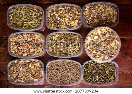 different various of muesli and granules for horses served in tester's boxes. close up . feeding and horse care concept. top view
