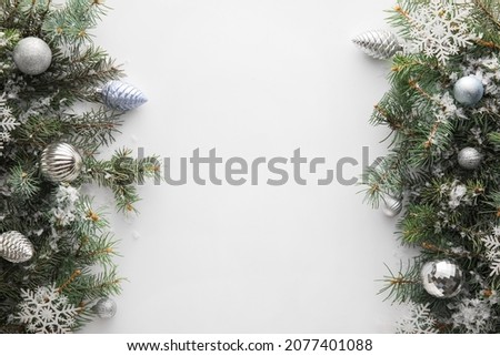 Christmas composition with fir branches, decorations and snow on white background, closeup
