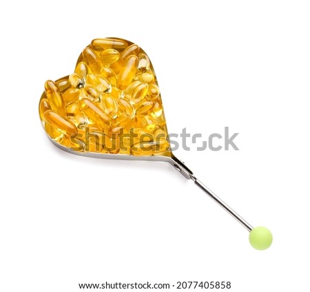 Heart shape made of fish oil capsules on white background