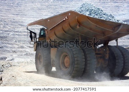 Huge dump truck loaded with mineral in a open pit copper mine in northern Chile