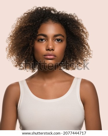 Beautiful african woman white t-shirt portrait afro haircut Color background pink Royalty-Free Stock Photo #2077444717