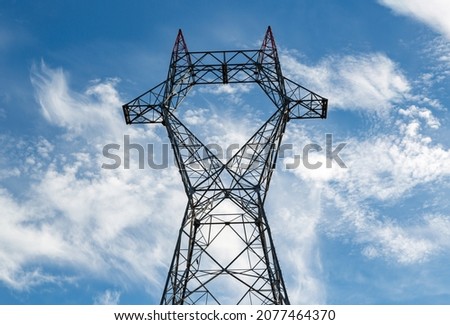 A newly assembled high voltage power line pole. High voltage pole with high voltage wires not yet connected.