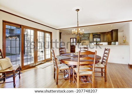 Bright dining room in luxury house with french door to walkout deck. View of kitchen room