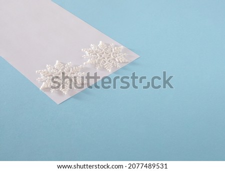 creative Christmas snowflakes with white paper against pastel blue background. minimal modern surreal creative idea with copy space. modern new year futurism concept