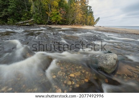 Spring landscape of a great blue heron and the Hurricane River captured with motion blur as it spills into Lake Superior, Pictured Rocks National Lakeshore, Michigan's Upper Peninsula, USA