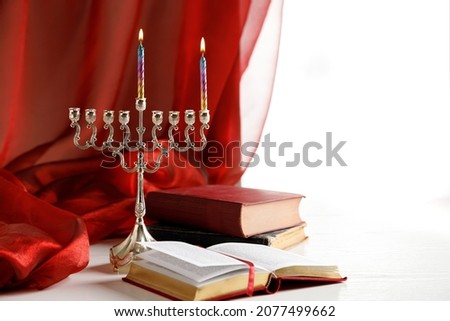 Day 1 of jewish religious holiday Hanukkah with holiday Hanukkah (traditional candelabra), Religious books (Tanakh)