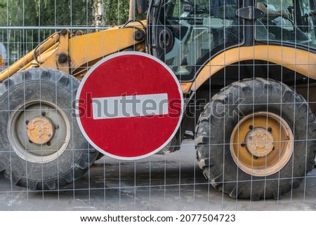 Road sign and road machinery on road construction