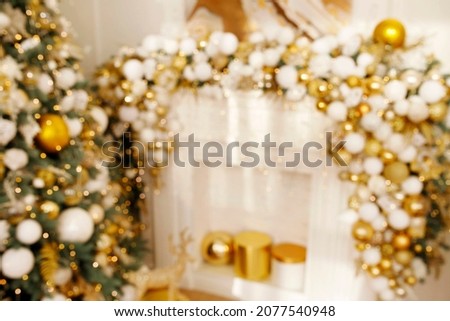 Blurred picture of Christmas tree decorations on white fireplace