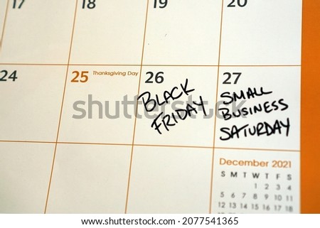 Calendar marked for Small Business Saturday - a reminder to shop local during the holiday season.                               Royalty-Free Stock Photo #2077541365