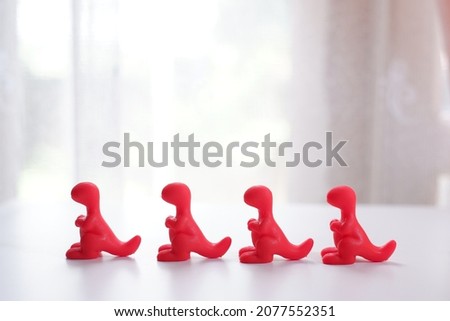 photo of dinosaur toys with various colors, suitable for background or wallpaper with empty space