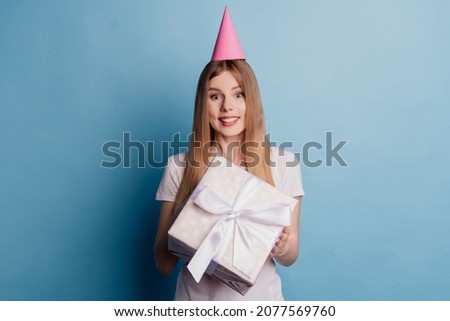 Photo of cheerful adorable cute nice dream lady hold present box wear cone cap on blue color background