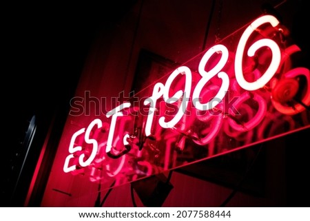 Neon sign outside shop at night