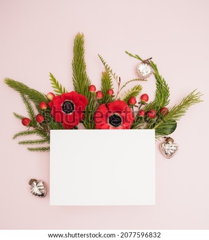 Festive fresh Christmas flower border and a blank card with holiday ornaments and blank card