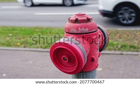 Classic Red Metal Fire Hydrant Located next to Busy Street