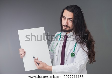 Handsome Italian doctor is showing empty white sign board.