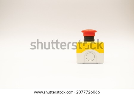 Stop Red Button and the Hand of Worker About to Press it. emergency stop button. Big Red emergency button or stop button for manual pressing. Royalty-Free Stock Photo #2077726066