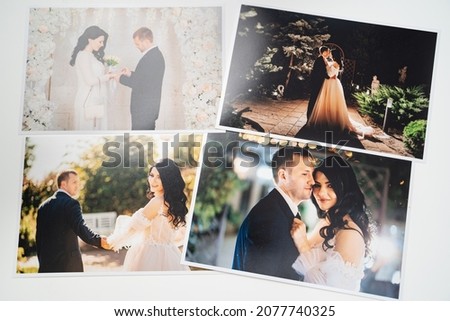 printed on paper photos of the bride and groom. professional printing of photographs in printing or in photo laboratory. the result of the photographer's work at the wedding.