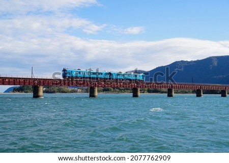 Diesel train crossing the iron bridge of the Yura River Royalty-Free Stock Photo #2077762909
