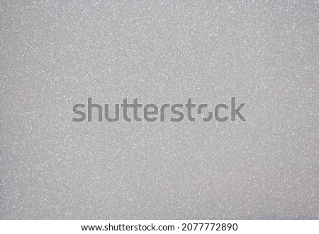 Monochrome dark gray surface with a scattering of small silvery sparkles. Background, pattern, texture. Royalty-Free Stock Photo #2077772890