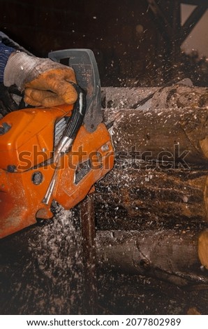 Kragujevac, Serbia. 10.15.2021. Outdoor photoshoot, Man chopping firewood with chainsaw.