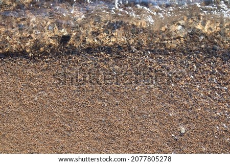 Lake Baikal is the largest lake in Siberia transparent waves and sand background