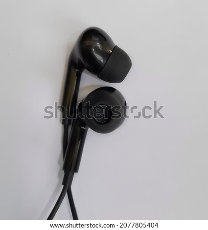 black headset partially photographed on a white background