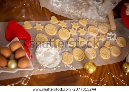 Merry Christmas and Happy Holiday. Christmas cookies close-up process cooking. Mom cooks with the children. High quality photo