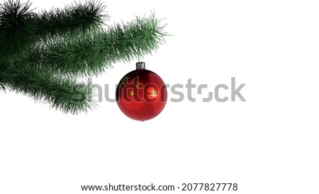 New Year's ball with the flag of China on a Christmas tree branch isolated on white background. Christmas and New Year concept.