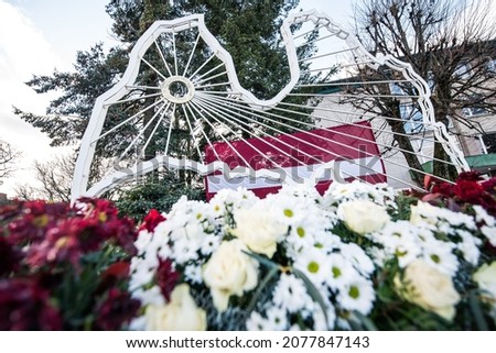 Latvian shape, flag and flowers in Kuldiga, Latvia. Day of proclamation of the Republic of Latvia.