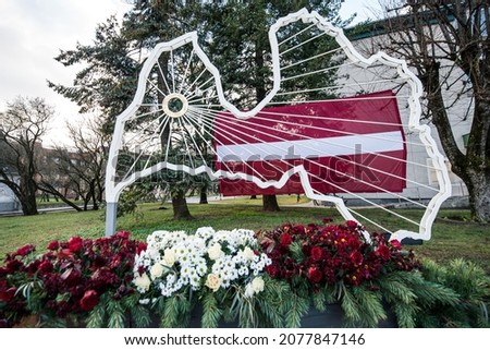 Latvian shape, flag and flowers in Kuldiga, Latvia. Day of proclamation of the Republic of Latvia.