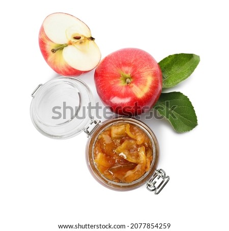 Tasty apple jam in glass jar and fresh fruits on white background, top view