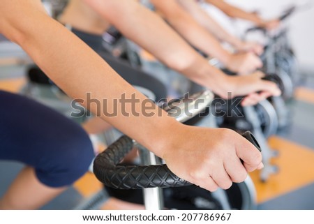 Spin class working out in a row at the gym Royalty-Free Stock Photo #207786967