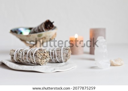 Smudge kit with white sage stick, abalone sea shell. Natural elements for cleansing environment from negative energy, adding positive vibes. Spriritual practices, witchcraft concept Royalty-Free Stock Photo #2077875259