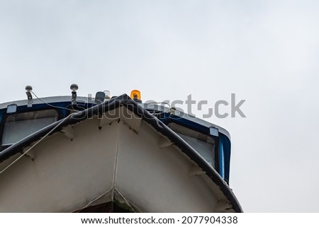 the hull of the ship is a view from below. the bow of the boat against a cloudy sky. background picture. space for printing.
