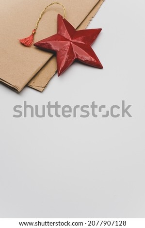 red painted decorative wooden star on a white background with copy space