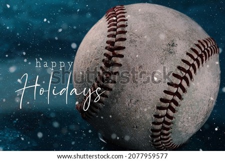 Baseball sports background for Christmas season with happy holidays text.