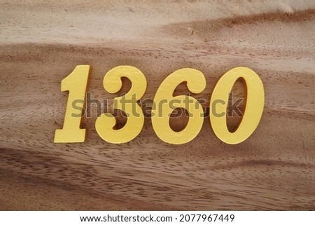 Golden Arabic numerals 1360 on a dark brown to white wood grain background.